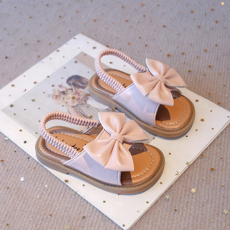 Kids Sandals for Girls Summer with Bow Design Sandals. Childrens Beach Shoes Open Toes, Flat Anti-skid Rubber Ankle Strap. Lots of stock except for size 26 in Beige, and please use the sizing chart available.