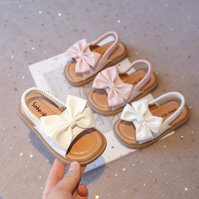 Kids Sandals for Girls  Summer with  Bow Design Sandals.   Childrens Beach Shoes Open Toes,  Flat Anti-skid Rubber Ankle Strap.  Lots of stock except for size 26 in Beige, and please use the sizing chart available.