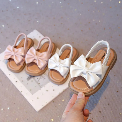 Kids Sandals for Girls  Summer with  Bow Design Sandals.   Childrens Beach Shoes Open Toes,  Flat Anti-skid Rubber Ankle Strap.  Lots of stock except for size 26 in Beige, and please use the sizing chart available.