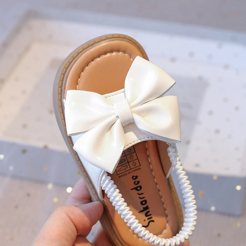 Kids Sandals for Girls  Summer with  Bow Design Sandals.   Childrens Beach Shoes Open Toes,  Flat Anti-skid Rubber Ankle Strap.  Lots of stock except for size 26 in Beige, and please use the sizing chart available.