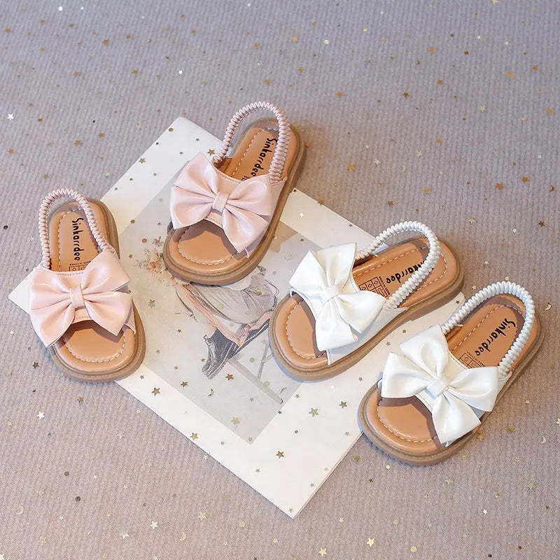 Kids Sandals for Girls  Summer with  Bow Design Sandals.   Childrens Beach Shoes Open Toes,  Flat Anti-skid Rubber Ankle Strap.  Lots of stock except for size 26 in Beige, and please use the sizing chart available.