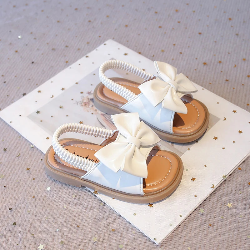 Kids Sandals for Girls  Summer with  Bow Design Sandals.   Childrens Beach Shoes Open Toes,  Flat Anti-skid Rubber Ankle Strap.  Lots of stock except for size 26 in Beige, and please use the sizing chart available.