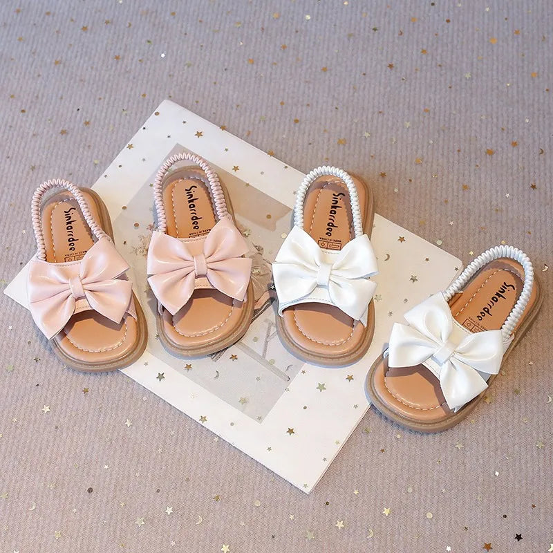 Kids Sandals for Girls  Summer with  Bow Design Sandals.   Childrens Beach Shoes Open Toes,  Flat Anti-skid Rubber Ankle Strap.  Lots of stock except for size 26 in Beige, and please use the sizing chart available.